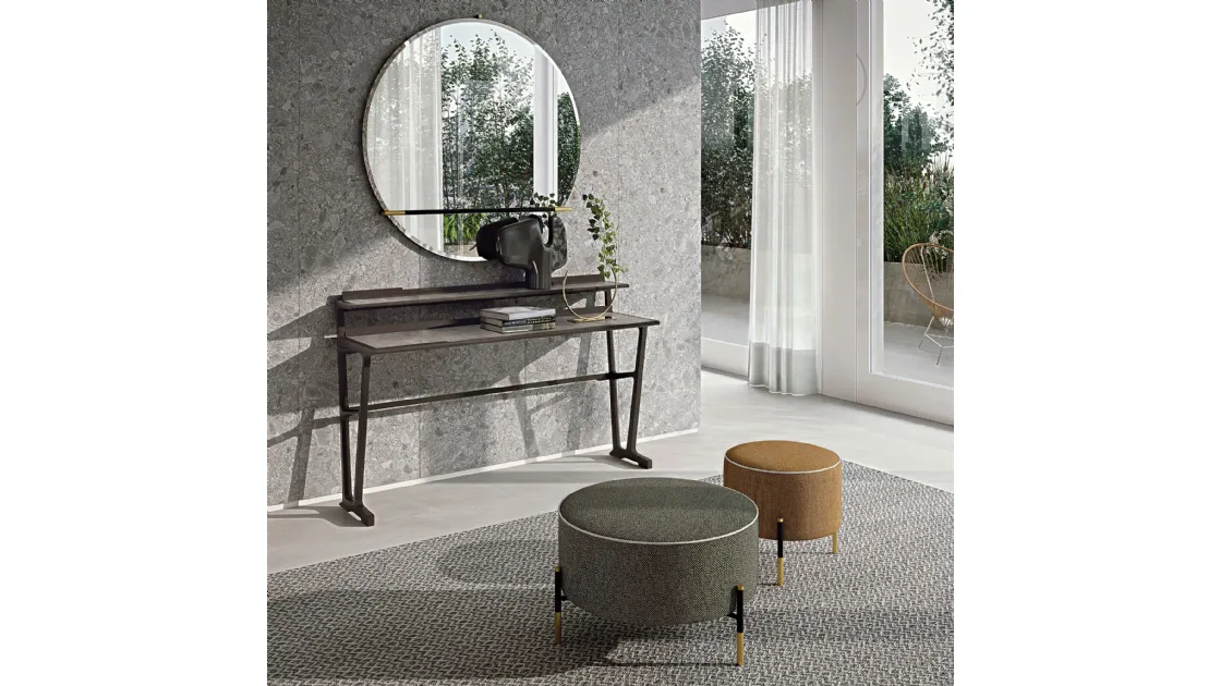 Pouf Kevin in fabric upholstery with a lightweight metal base and contrasting details by Frigerio.