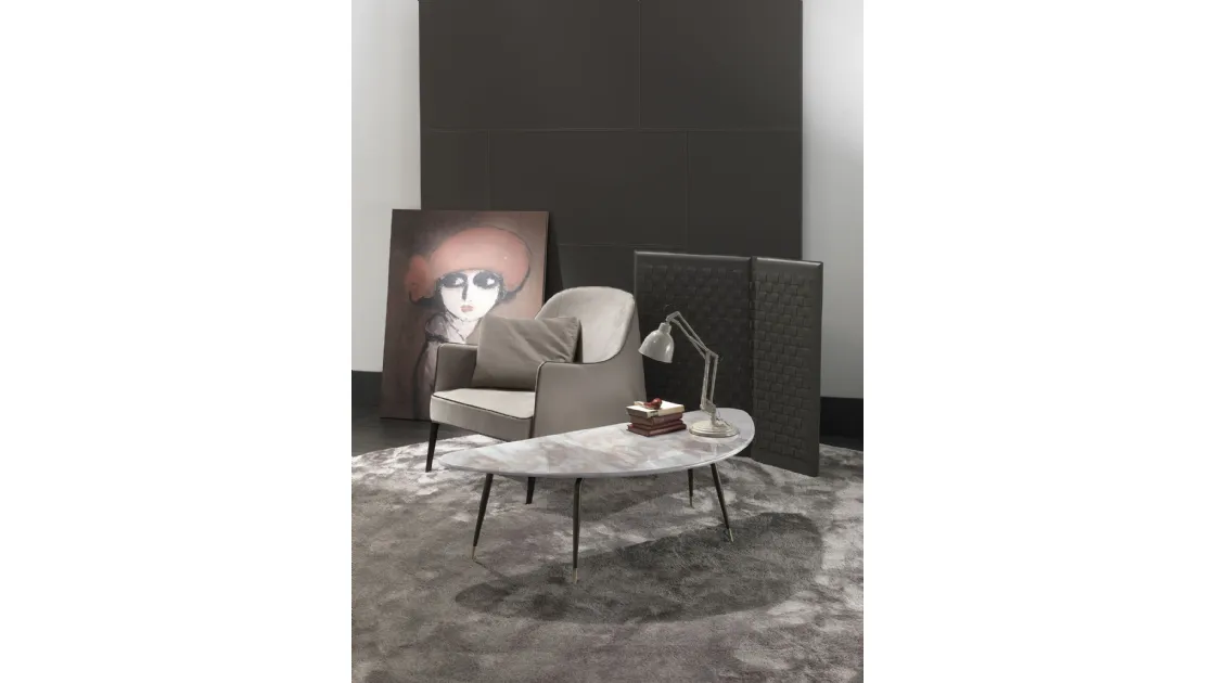 Irregular shaped coffee table with marble top and brass-tipped, burnished metal base Smart by Frigerio.