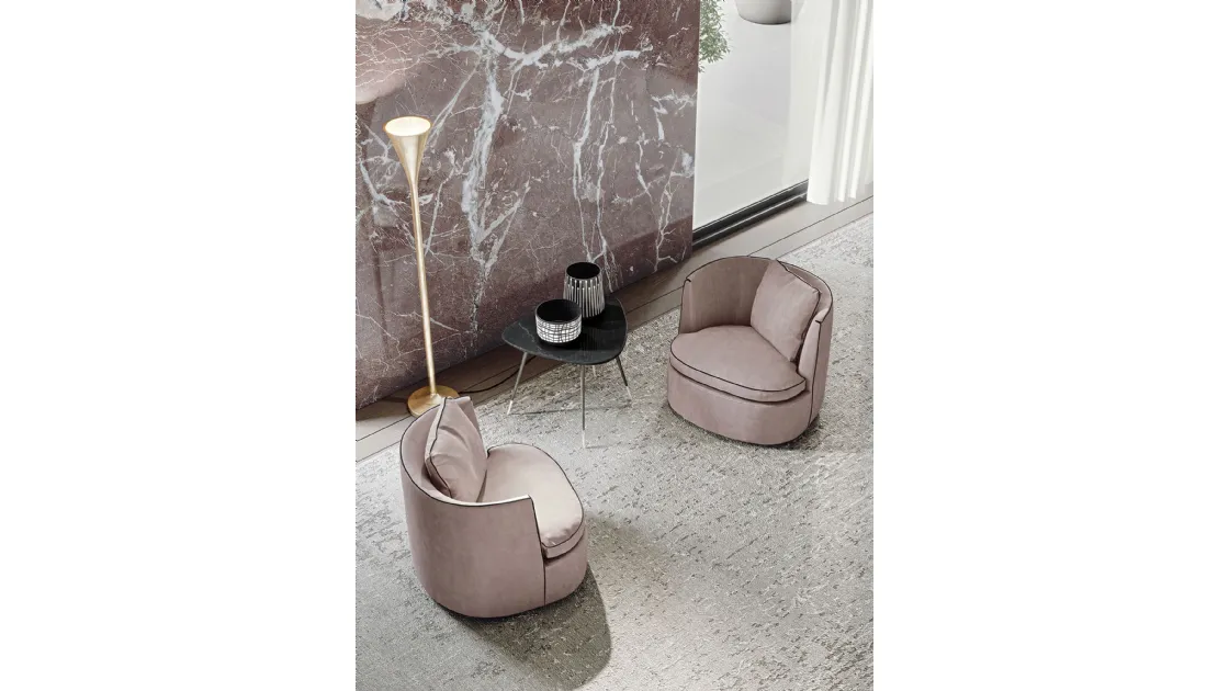 Irregular shaped coffee table with chamfered edges in marble with Smart metal base by Frigerio.