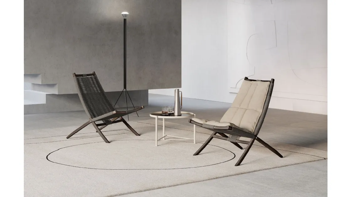 Huli armchair in synthetic fiber covered in padded fabric with solid wood structure by Frigerio.