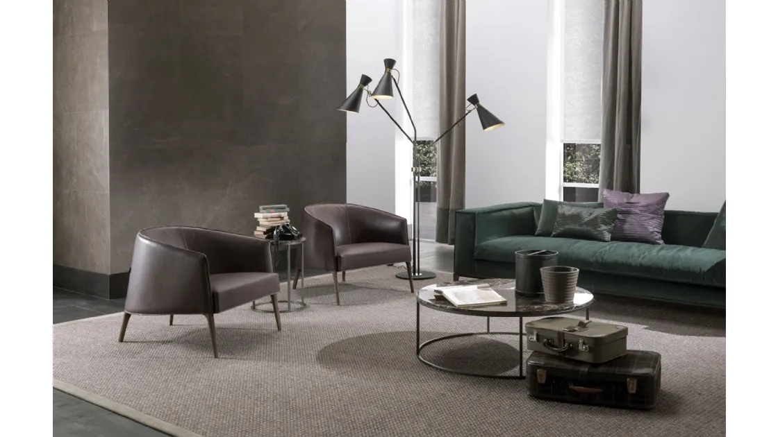 Jackie enveloping armchair in leather with solid wood feet by Frigerio.