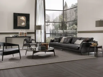 Lizzye armchair in wood with Frigerio leather seat.