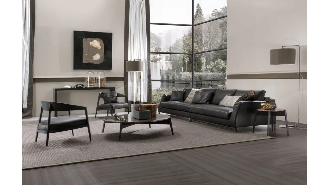 Lizzye armchair in wood with Frigerio leather seat.