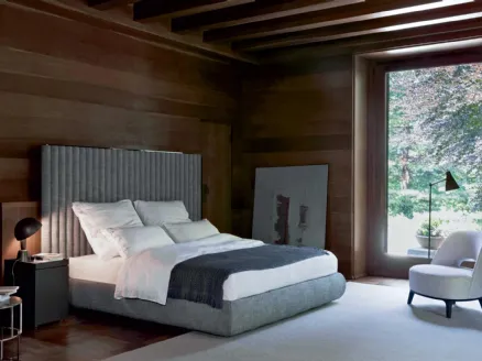 Upholstered bed with Biarritz headboard by Flexform.
