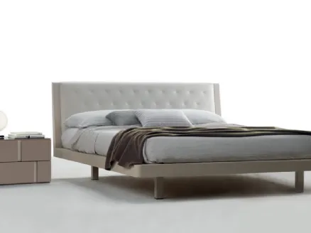 Matt lacquered bed with headboard covered in Smeraldo quilted eco-leather by Tagliabue Mobili