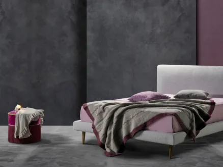 Simple and elegant fabric bed with Kappa Ring 14 headboard by Excò.
