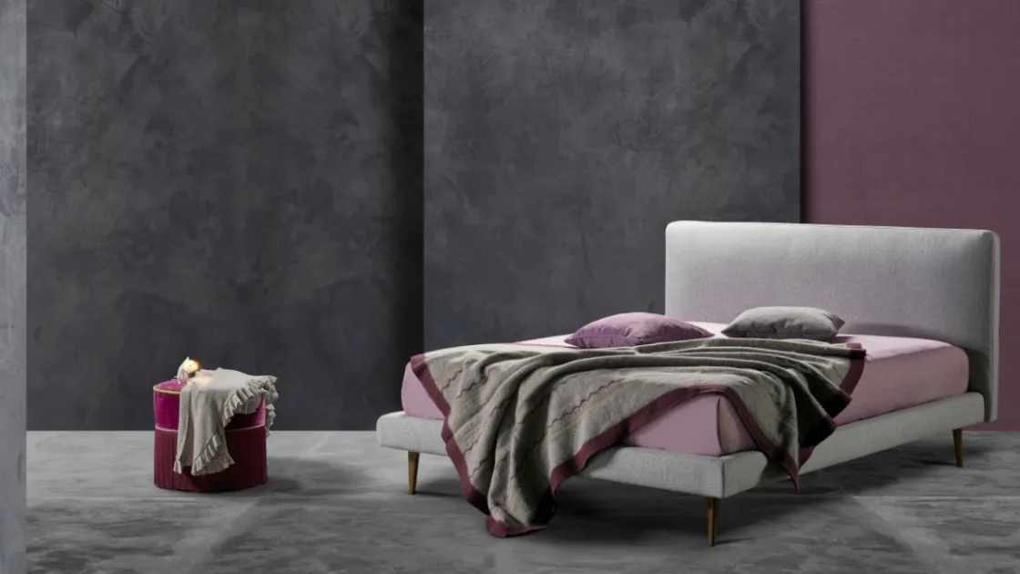 Simple and elegant fabric bed with Kappa Ring 14 headboard by Excò.