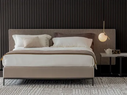 Upholstered fabric bed with Kelly Textile headboard by Oggioni.