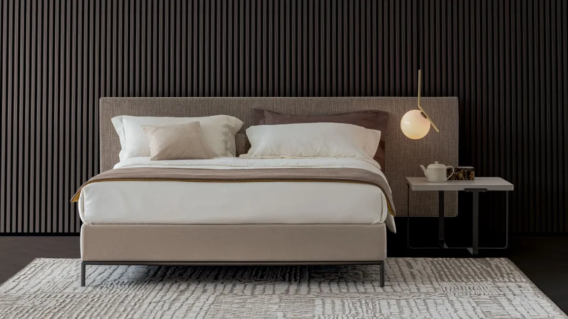 Upholstered fabric bed with Kelly Textile headboard by Oggioni.