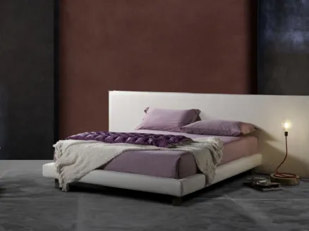 Padded bed with simple and elegant lines and geometric headboard Milo Ring 14 by Excò.