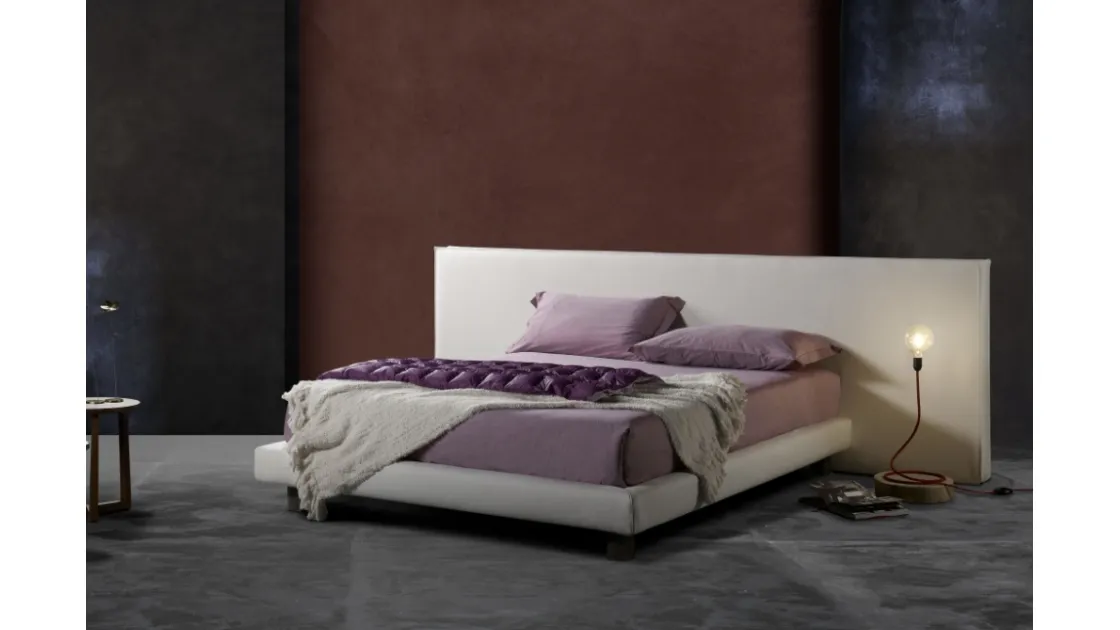 Padded bed with simple and elegant lines and geometric headboard Milo Ring 14 by Excò.