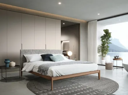 Walnut Canaletto bed with headboard upholstered in Novamobili fabric.