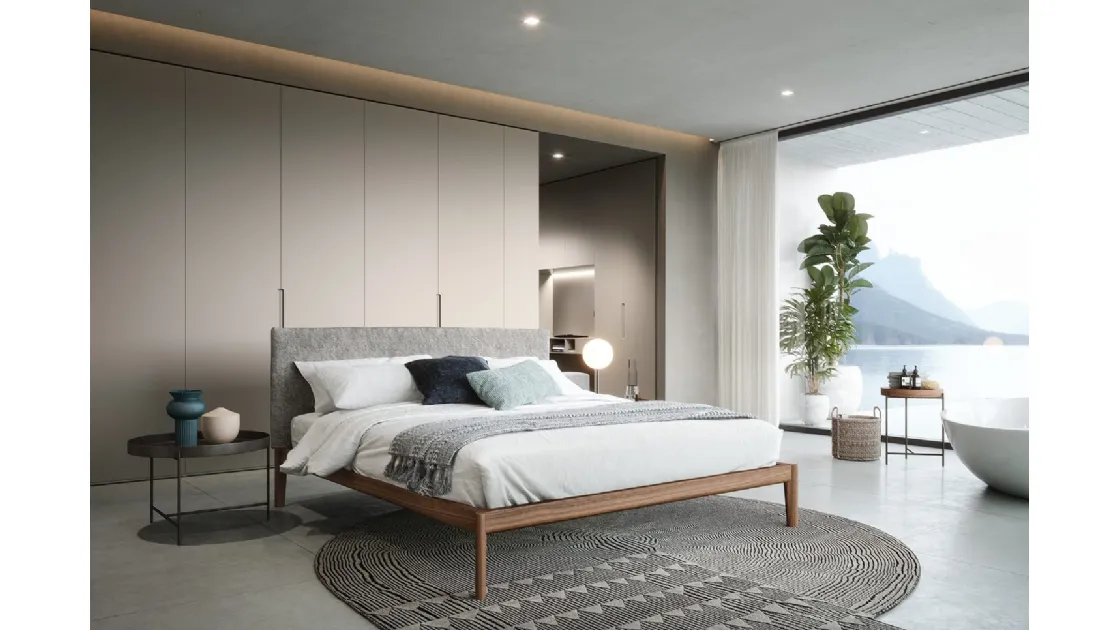 Walnut Canaletto bed with headboard upholstered in Novamobili fabric.