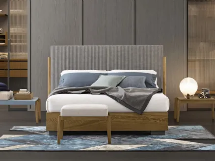 Bed with headboard upholstered in quilted fabric with side posts in solid Ash wood and base in Oggioni's Promenade wood.