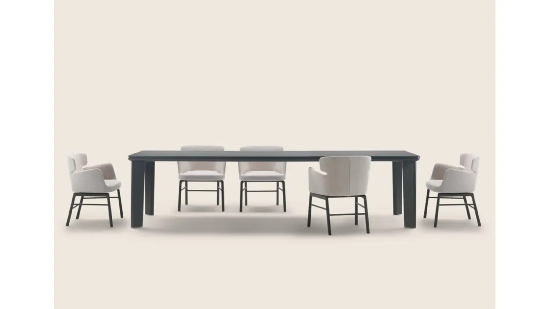 Arnold table with glass top and wooden structure by Flexform.