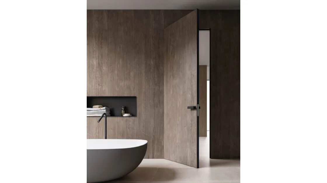 Hinged interior door in stoneware and Materica Filomuro stone by ADL.