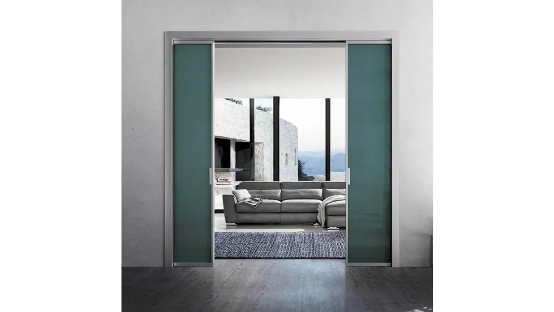 Sliding indoor door in colored glass with Doal's Zeus Disappearing aluminum frame.